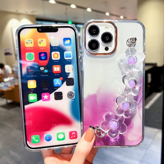 Caja con diseño de mármol y halo dorado y pulsera de flores