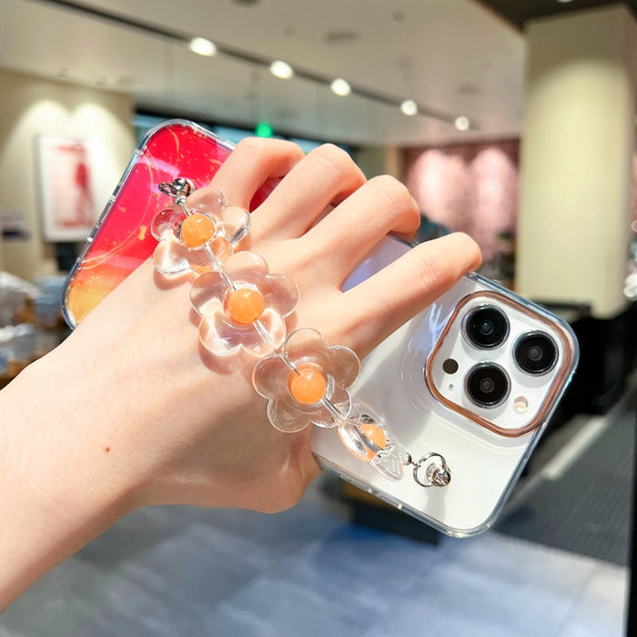 Caja con diseño de mármol y halo dorado y pulsera de flores