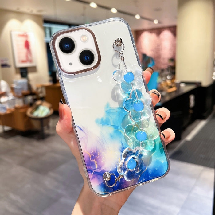 Caja con diseño de mármol y halo dorado y pulsera de flores