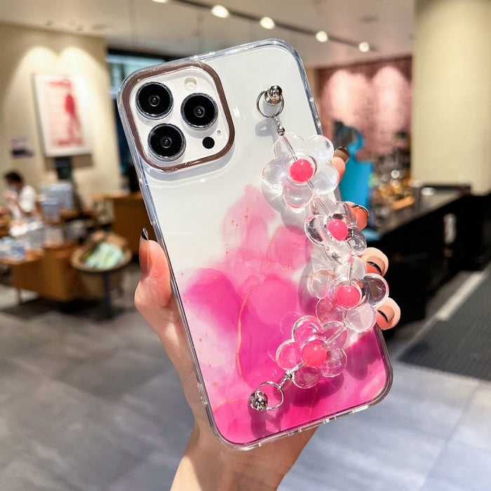 Caja con diseño de mármol y halo dorado y pulsera de flores