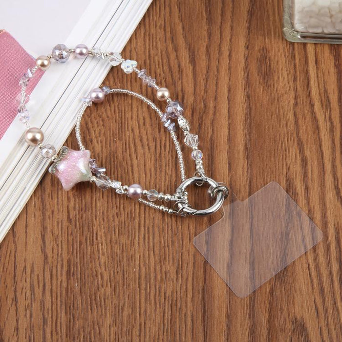 Cadena para teléfono con forma de estrella de cinco puntas pintada al óleo y con cordón de sujeción.