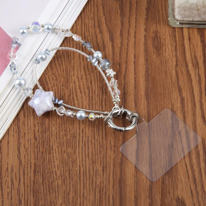 Cadena para teléfono con forma de estrella de cinco puntas pintada al óleo y con cordón de sujeción.