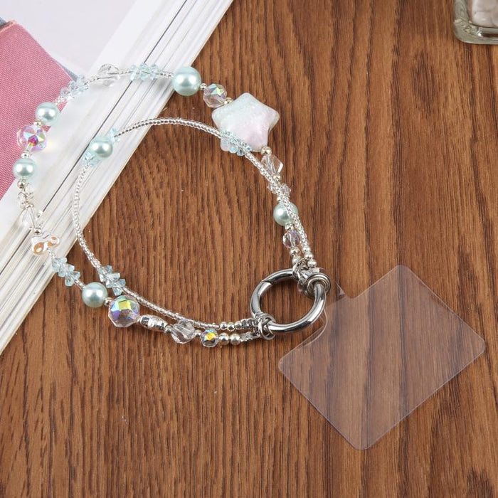 Cadena para teléfono con forma de estrella de cinco puntas pintada al óleo y con cordón de sujeción.