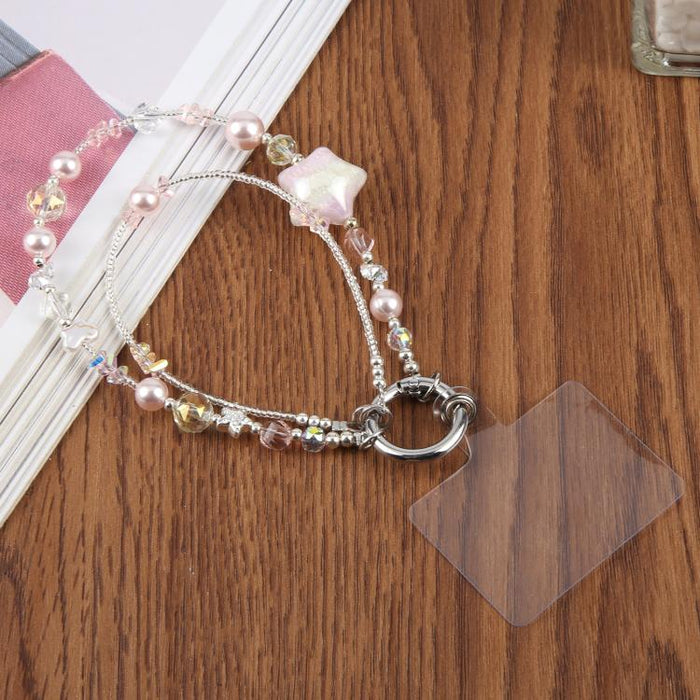 Cadena para teléfono con forma de estrella de cinco puntas pintada al óleo y con cordón de sujeción.