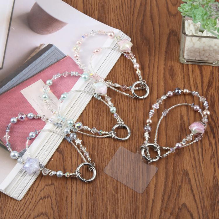 Cadena para teléfono con forma de estrella de cinco puntas pintada al óleo y con cordón de sujeción.