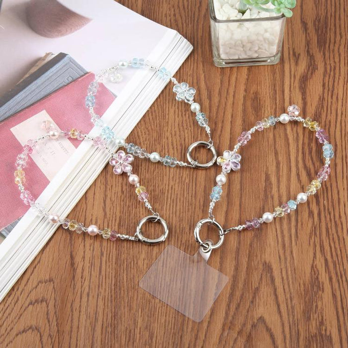 Correa de muñeca para teléfono con colgante de flores y cuentas, con almohadilla de sujeción para mujeres y niñas.
