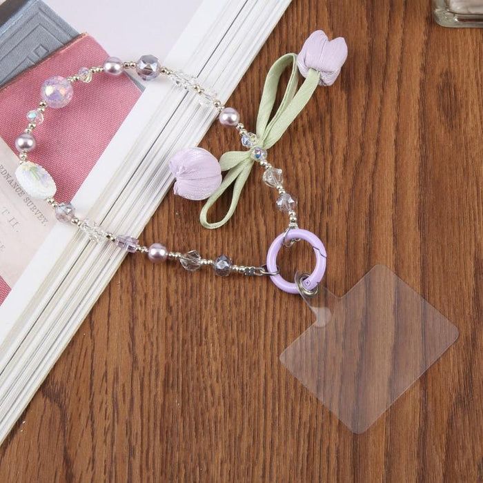 Correa de muñeca para teléfono con colgante de flor de tulipán y almohadilla de sujeción para mujeres y niñas.