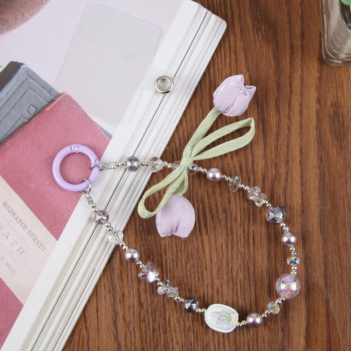 Correa de muñeca para teléfono con colgante de flor de tulipán y almohadilla de sujeción para mujeres y niñas.