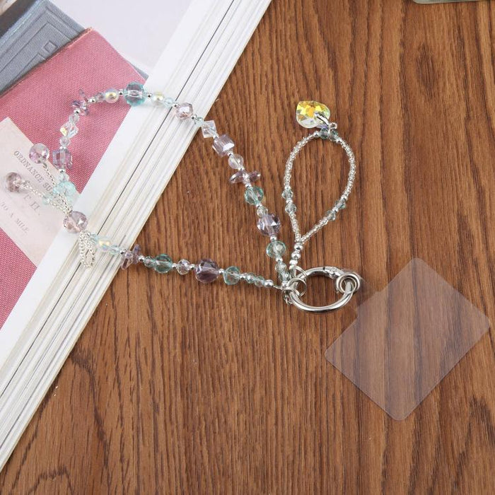 Pulsera con colgante de teléfono con cuentas y almohadilla de sujeción para mujeres y niñas.