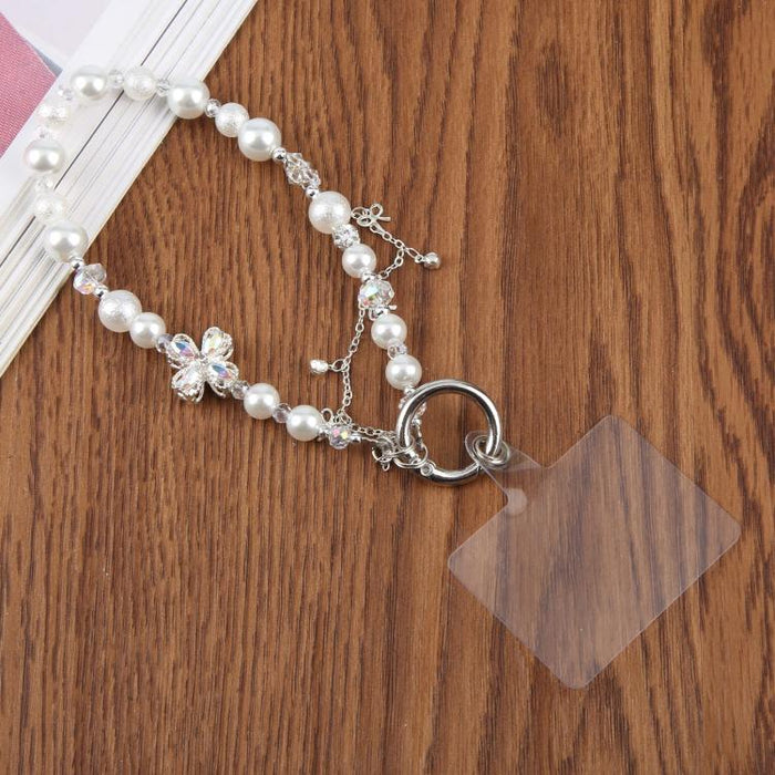 Pulsera con colgante de trébol de cuatro hojas, borla y cuentas, con almohadilla de sujeción para mujer y niña.
