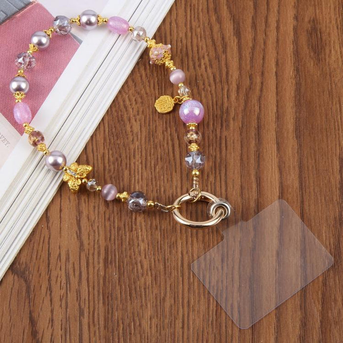 Cadena corta de cuentas con forma de mariposa ojo de gato y correa de muñeca con almohadilla de sujeción para mujeres y niñas.