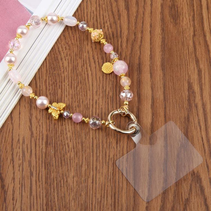 Cadena corta de cuentas con forma de mariposa ojo de gato y correa de muñeca con almohadilla de sujeción para mujeres y niñas.