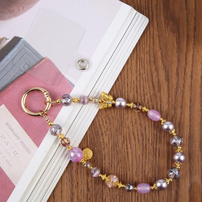 Cadena corta de cuentas con forma de mariposa ojo de gato y correa de muñeca con almohadilla de sujeción para mujeres y niñas.