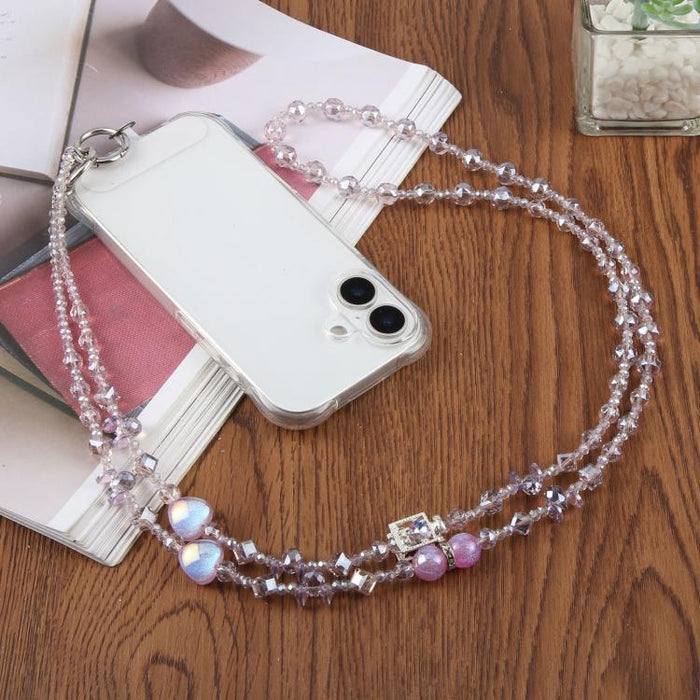 Colgante para teléfono con forma de corazón y cuentas, con cordón cruzado y almohadilla de sujeción.